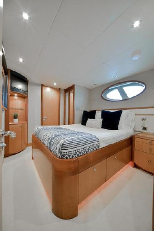 a bed with a mirror above it aboard 2007 LAZZARA 84 MOTOR Yacht for Sale