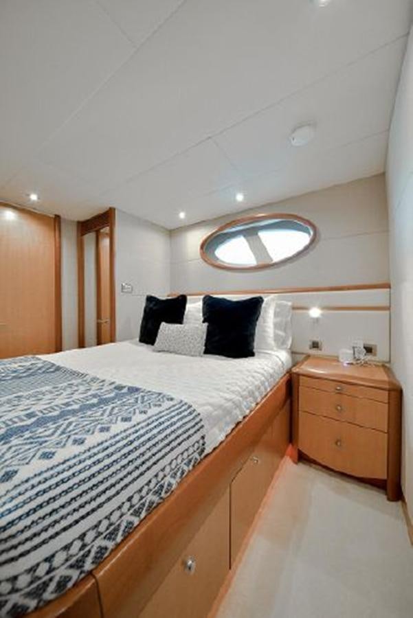 a bedroom with a bed and a mirror aboard 2007 LAZZARA 84 MOTOR Yacht for Sale