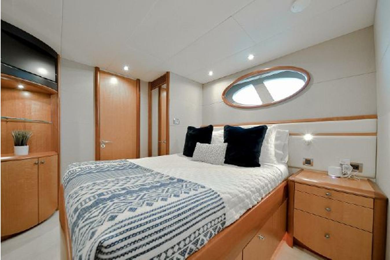 a bedroom with a bed and a mirror aboard 2007 LAZZARA 84 MOTOR Yacht for Sale