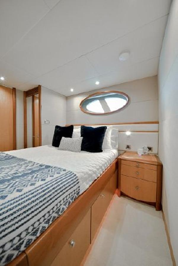 a bed with a mirror above it aboard 2007 LAZZARA 84 MOTOR Yacht for Sale