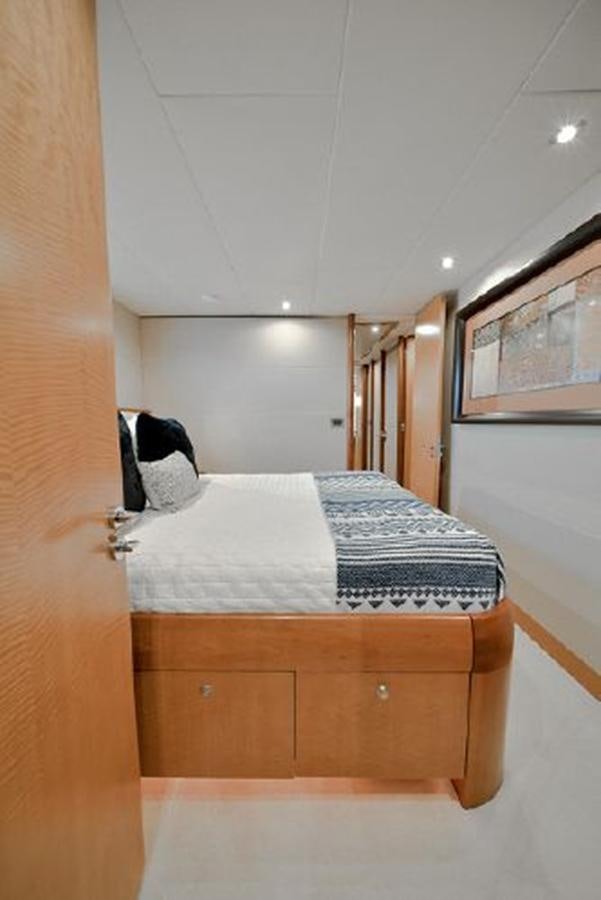 a bed with a white sheet aboard 2007 LAZZARA 84 MOTOR Yacht for Sale