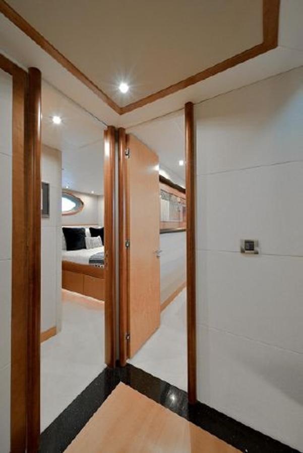 a room with a bed and a door aboard 2007 LAZZARA 84 MOTOR Yacht for Sale