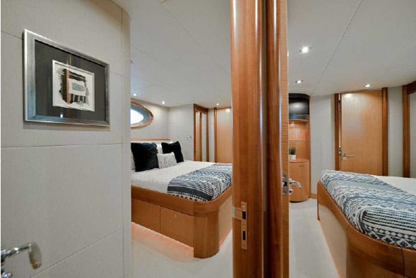 a bathroom with a bed and a mirror aboard 2007 LAZZARA 84 MOTOR Yacht for Sale