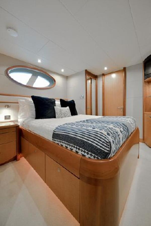 a bed with a mirror above it aboard 2007 LAZZARA 84 MOTOR Yacht for Sale