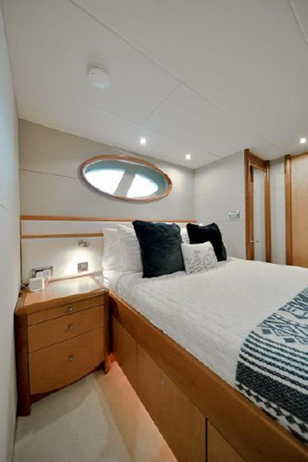 a bed with a mirror above it aboard 2007 LAZZARA 84 MOTOR Yacht for Sale