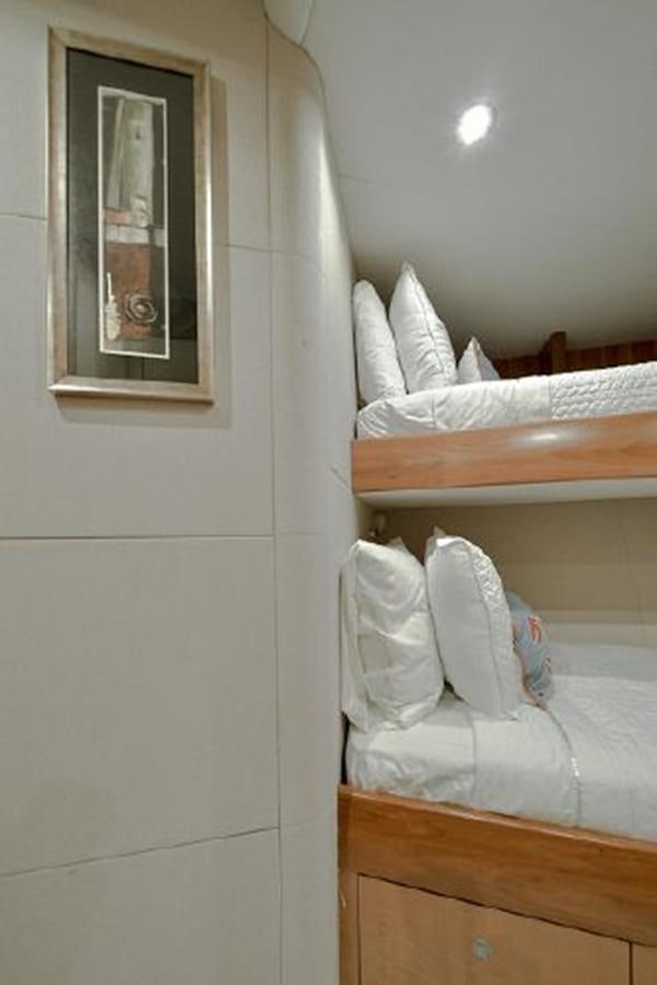 a room with a bed and a mirror aboard 2007 LAZZARA 84 MOTOR Yacht for Sale