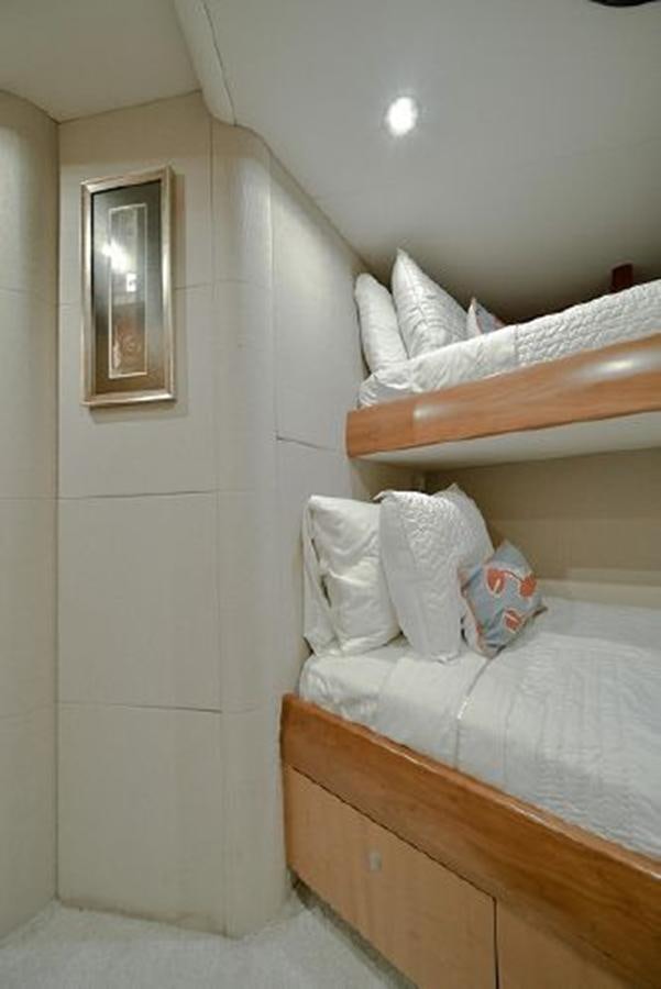 a bed with a white pillow and a wooden headboard aboard 2007 LAZZARA 84 MOTOR Yacht for Sale