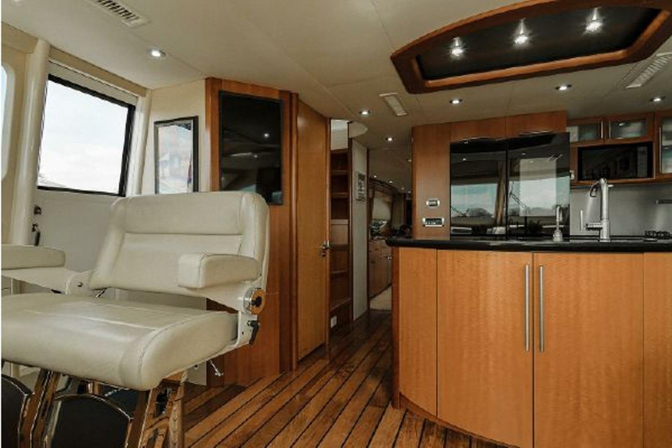 a room with a couch and a table and a chair aboard 2007 LAZZARA 84 MOTOR Yacht for Sale