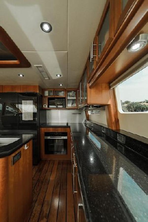 a kitchen with a large island aboard 2007 LAZZARA 84 MOTOR Yacht for Sale