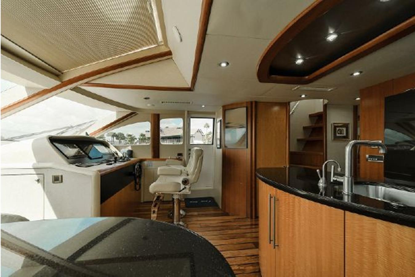 a kitchen with a table and chairs aboard 2007 LAZZARA 84 MOTOR Yacht for Sale