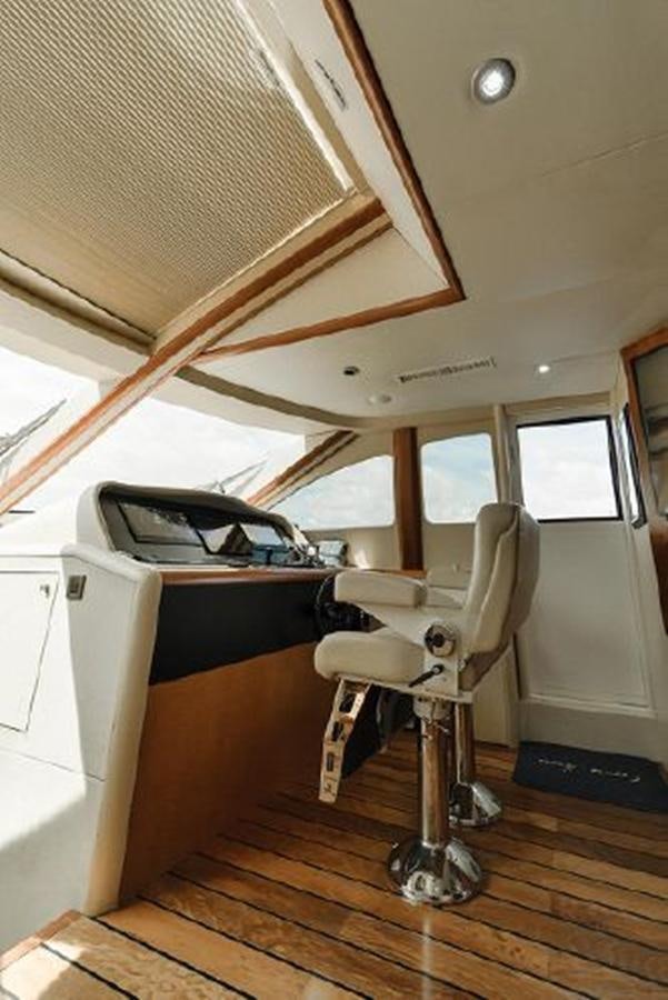 a white chair in a room aboard 2007 LAZZARA 84 MOTOR Yacht for Sale