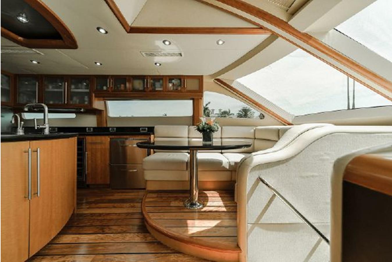 a room with a table and chairs aboard 2007 LAZZARA 84 MOTOR Yacht for Sale