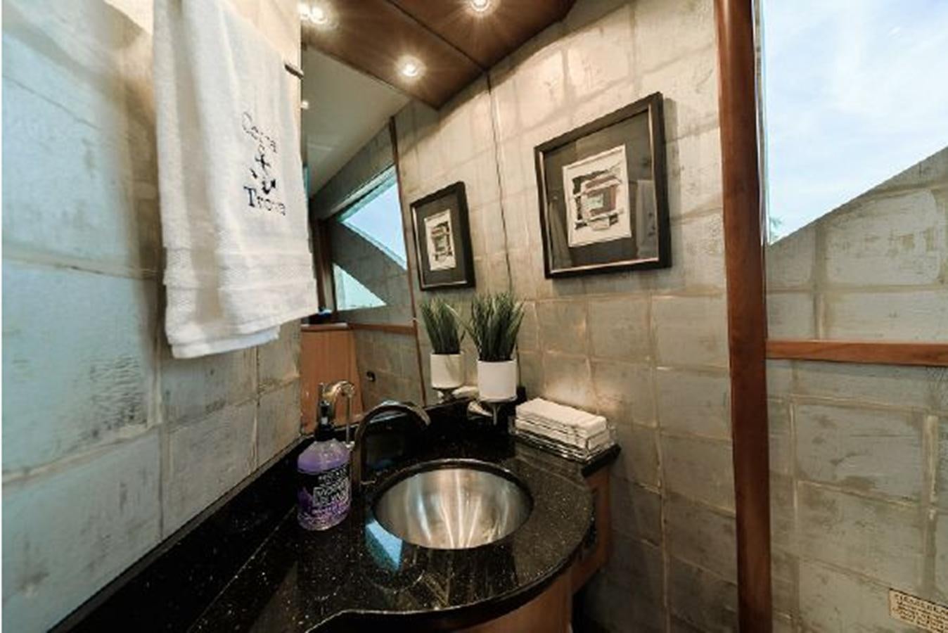 a kitchen with a sink and a countertop aboard 2007 LAZZARA 84 MOTOR Yacht for Sale