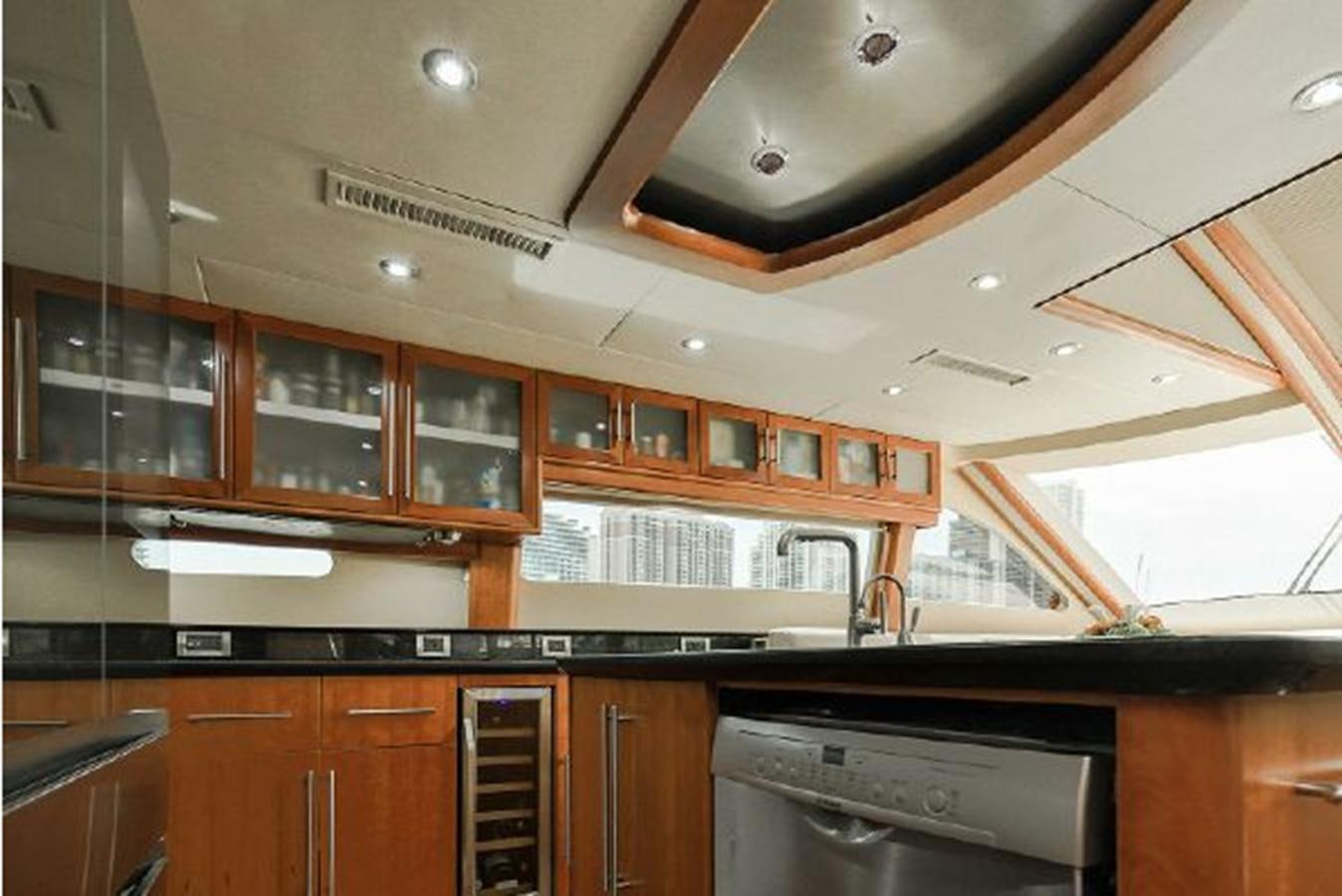 a kitchen with wooden cabinets aboard 2007 LAZZARA 84 MOTOR Yacht for Sale