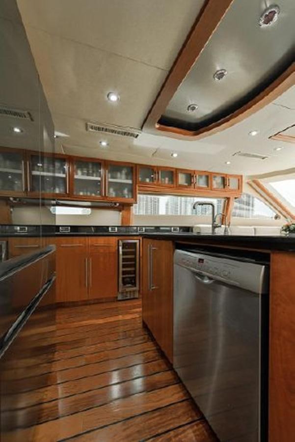 a kitchen with wooden cabinets aboard 2007 LAZZARA 84 MOTOR Yacht for Sale