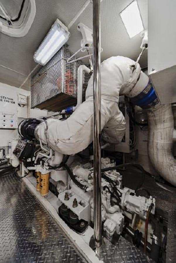 a person in a white coat working on a machine aboard 2007 LAZZARA 84 MOTOR Yacht for Sale