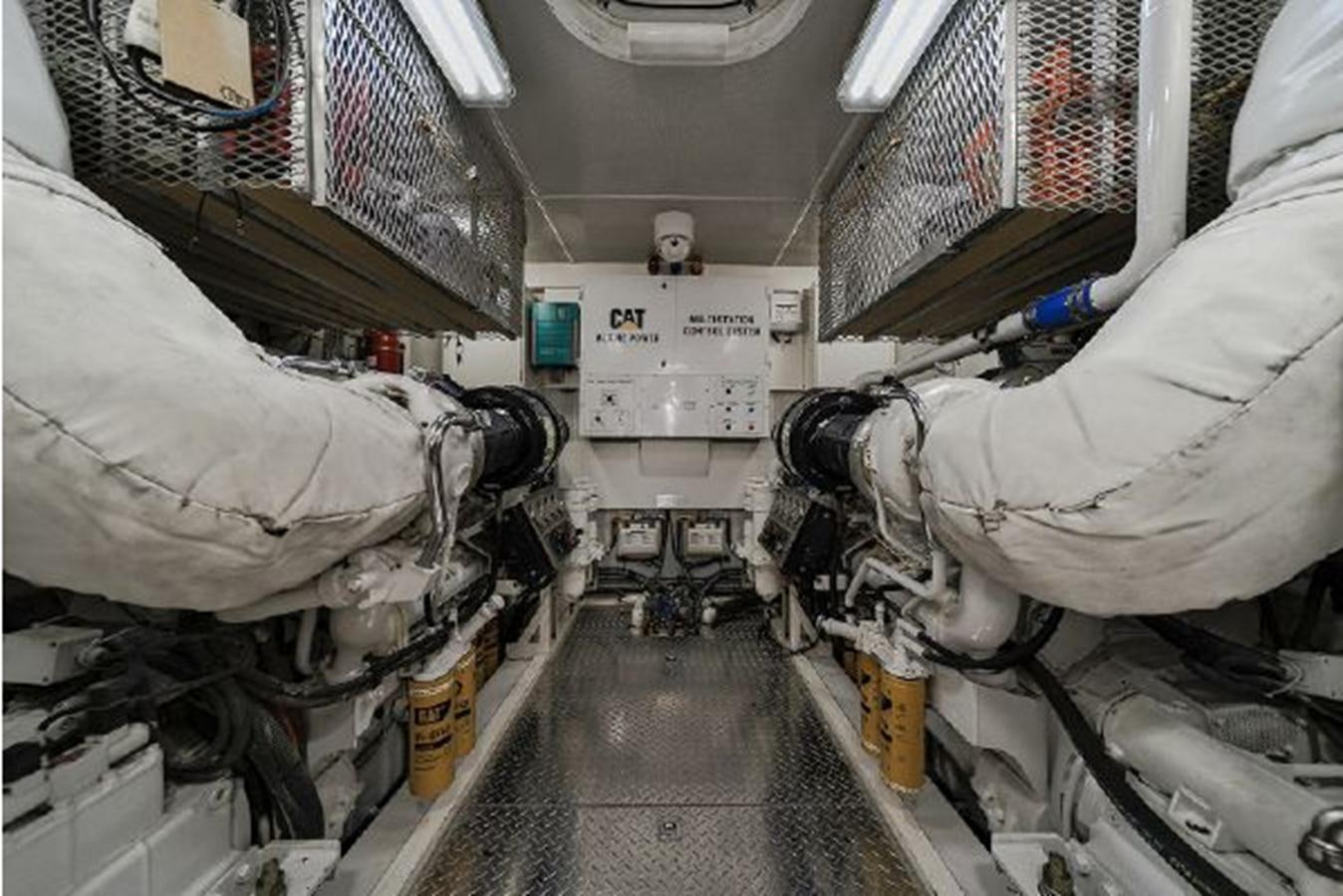 a person in a white coat in a room with white walls and a white floor and a few aboard 2007 LAZZARA 84 MOTOR Yacht for Sale
