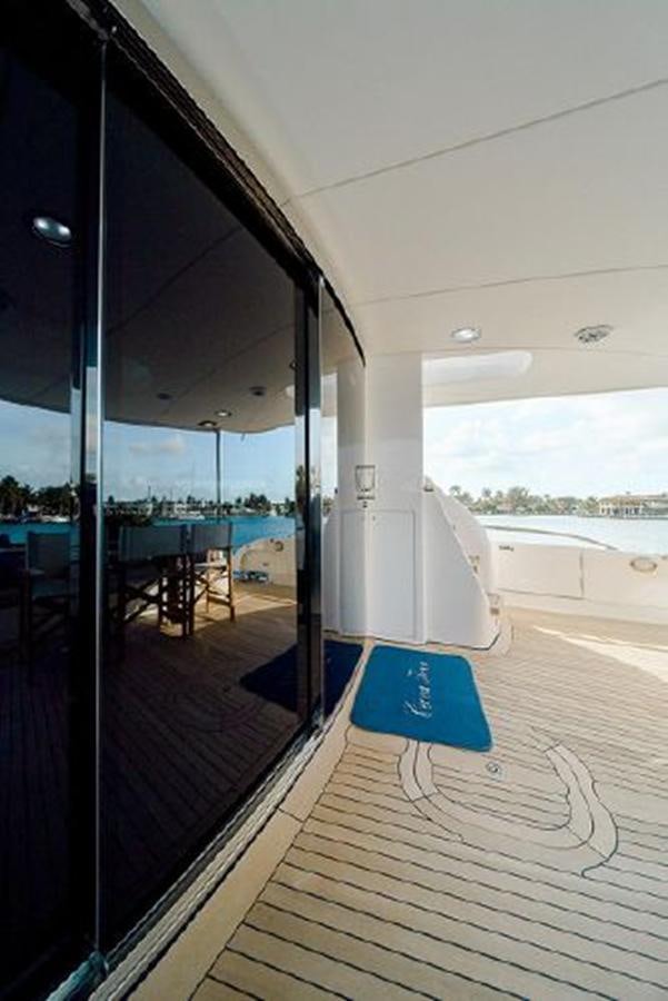 a wood deck with a large window aboard 2007 LAZZARA 84 MOTOR Yacht for Sale