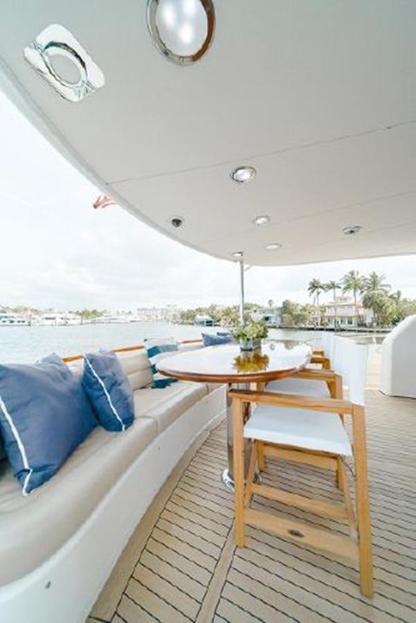 a room with a table and chairs aboard 2007 LAZZARA 84 MOTOR Yacht for Sale