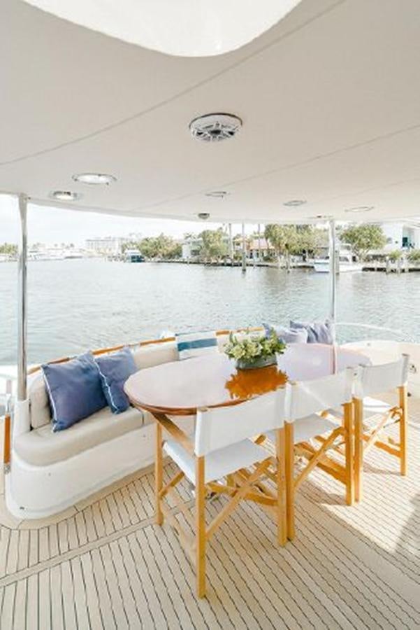 a table on a balcony aboard 2007 LAZZARA 84 MOTOR Yacht for Sale