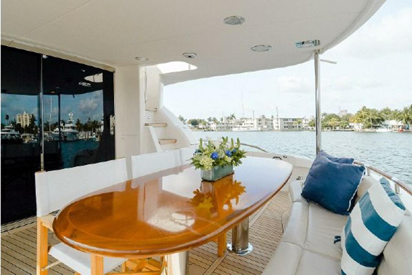 a table with a vase of flowers on it aboard 2007 LAZZARA 84 MOTOR Yacht for Sale