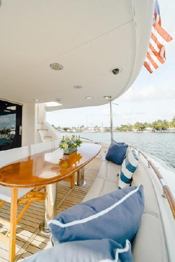 a table and chairs on a boat aboard 2007 LAZZARA 84 MOTOR Yacht for Sale