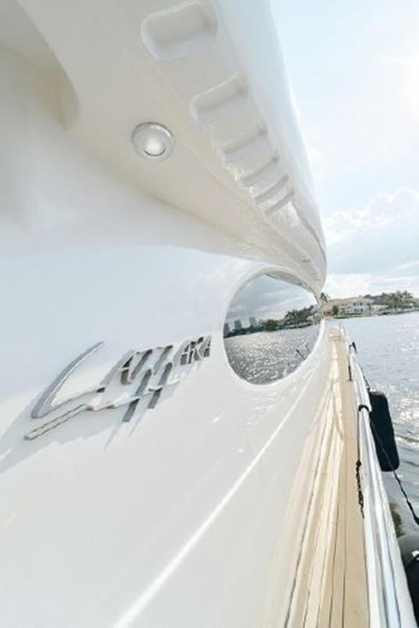 a white boat with a white sail aboard 2007 LAZZARA 84 MOTOR Yacht for Sale