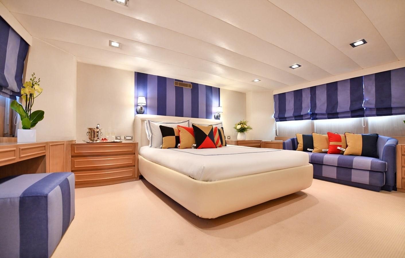 a large room with a couch and a television aboard SOMETHING COOL Yacht for Sale