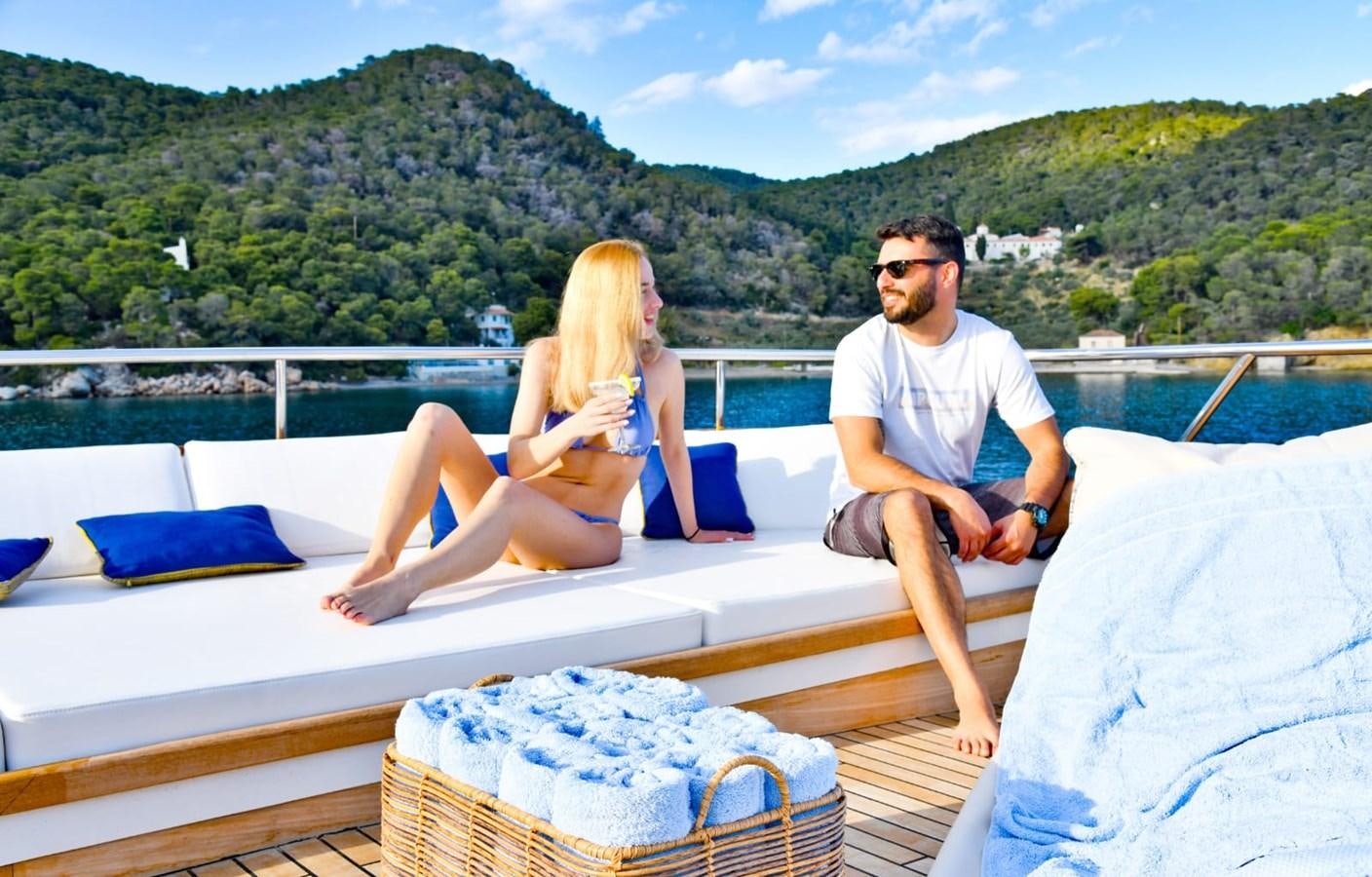 a man and a woman sitting on a boat aboard SOMETHING COOL Yacht for Sale