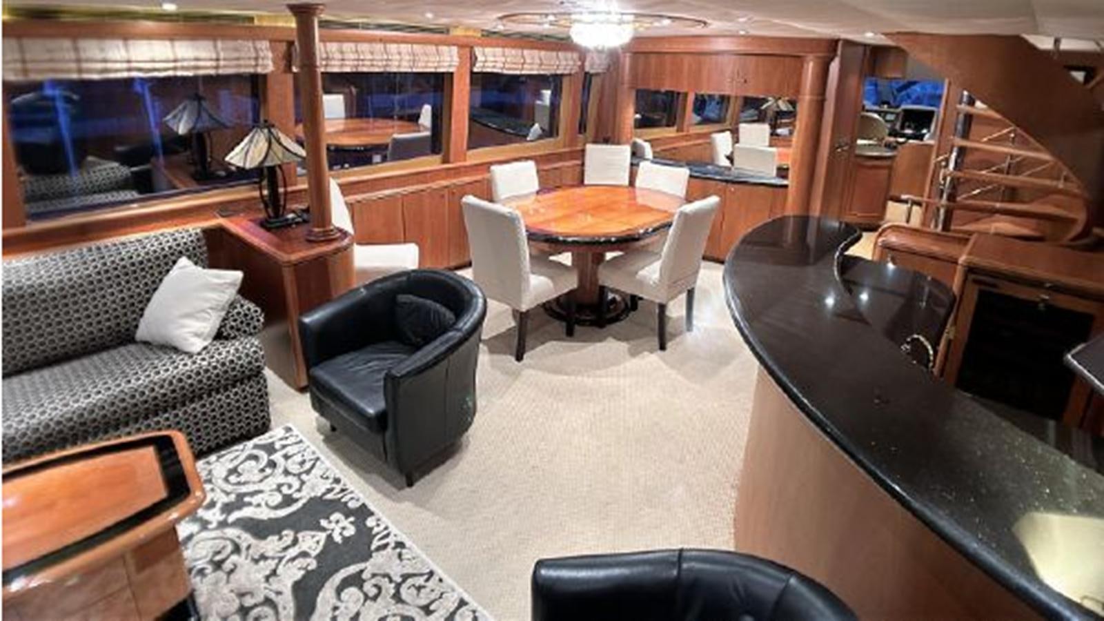 a room with a couch and a table and chairs aboard 2006 CHEOY LEE MOTOR Yacht for Sale