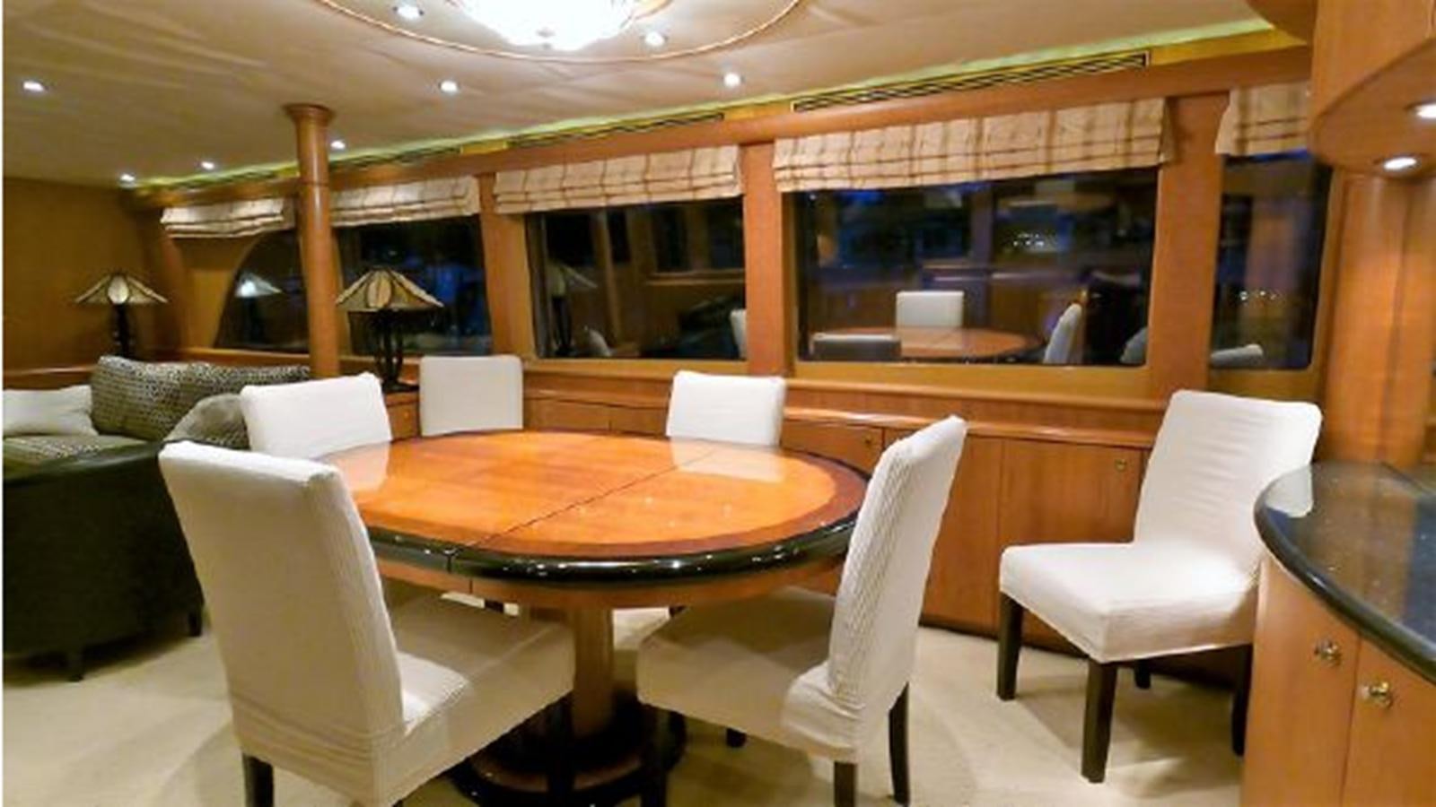 a room with a table chairs and a couch aboard 2006 CHEOY LEE MOTOR Yacht for Sale