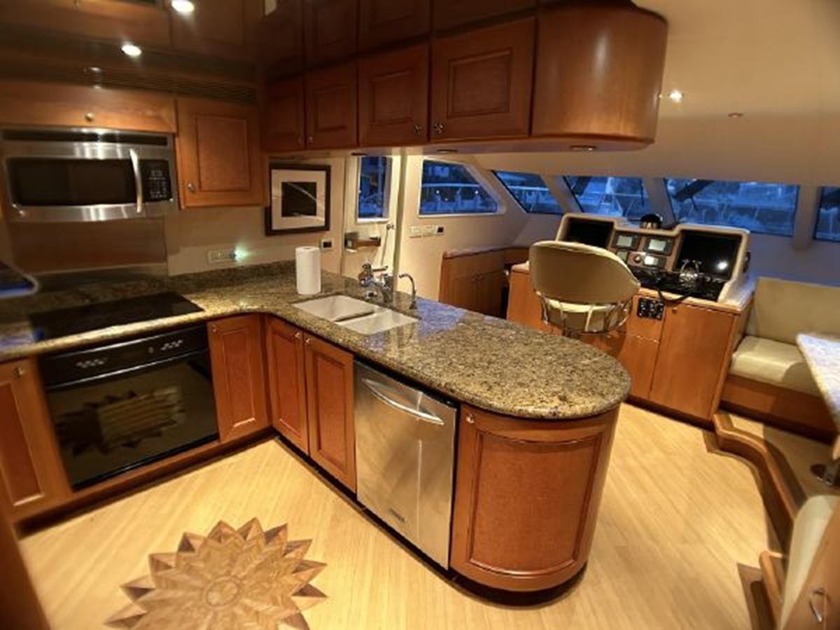 a kitchen with wooden cabinets aboard 2006 CHEOY LEE MOTOR Yacht for Sale