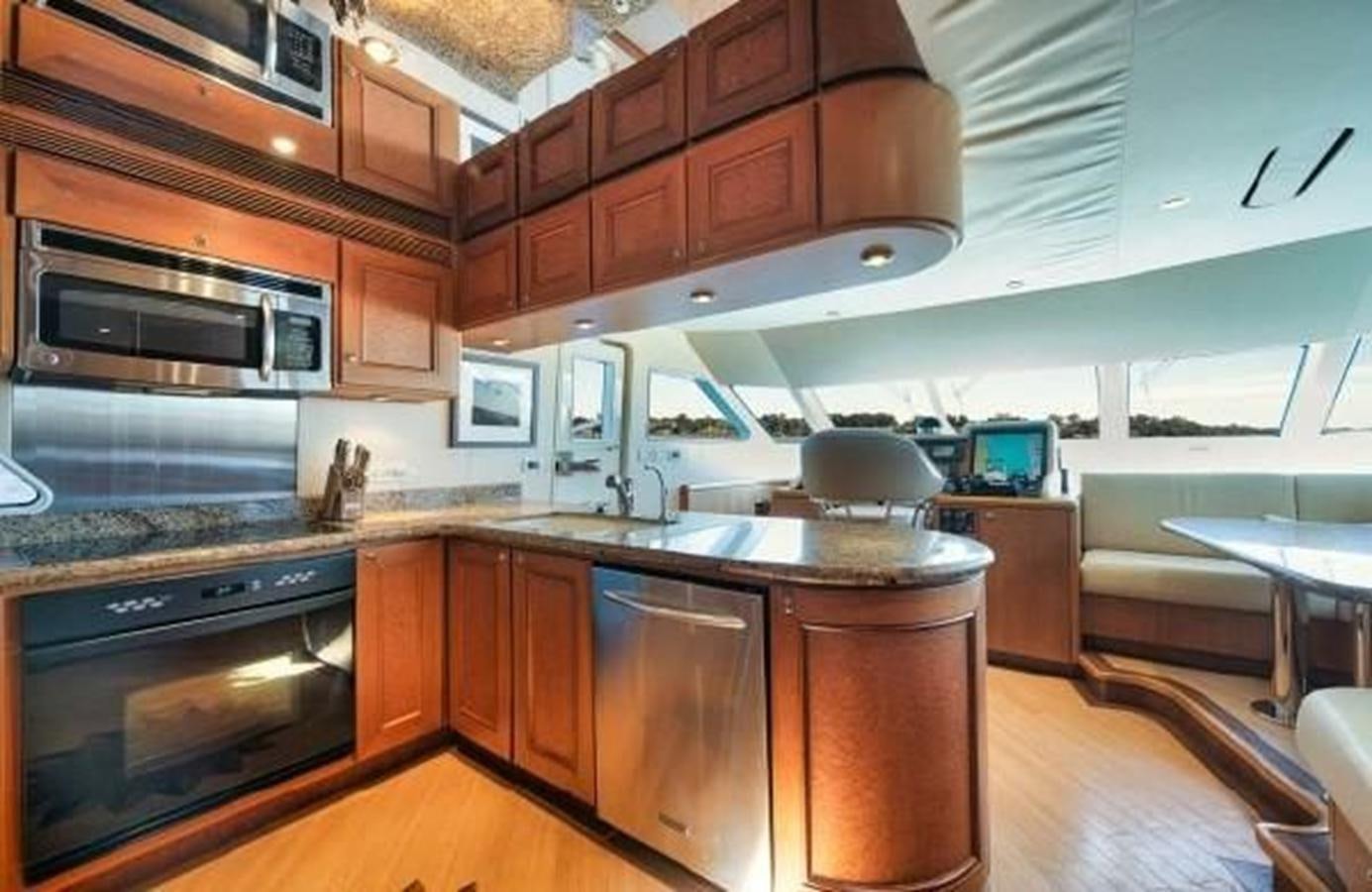 a kitchen with wooden cabinets aboard 2006 CHEOY LEE MOTOR Yacht for Sale