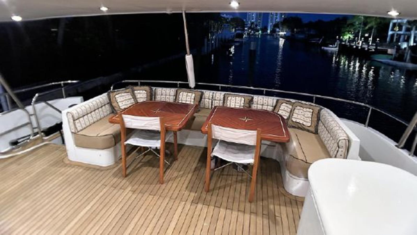 a room with a table and chairs aboard 2006 CHEOY LEE MOTOR Yacht for Sale