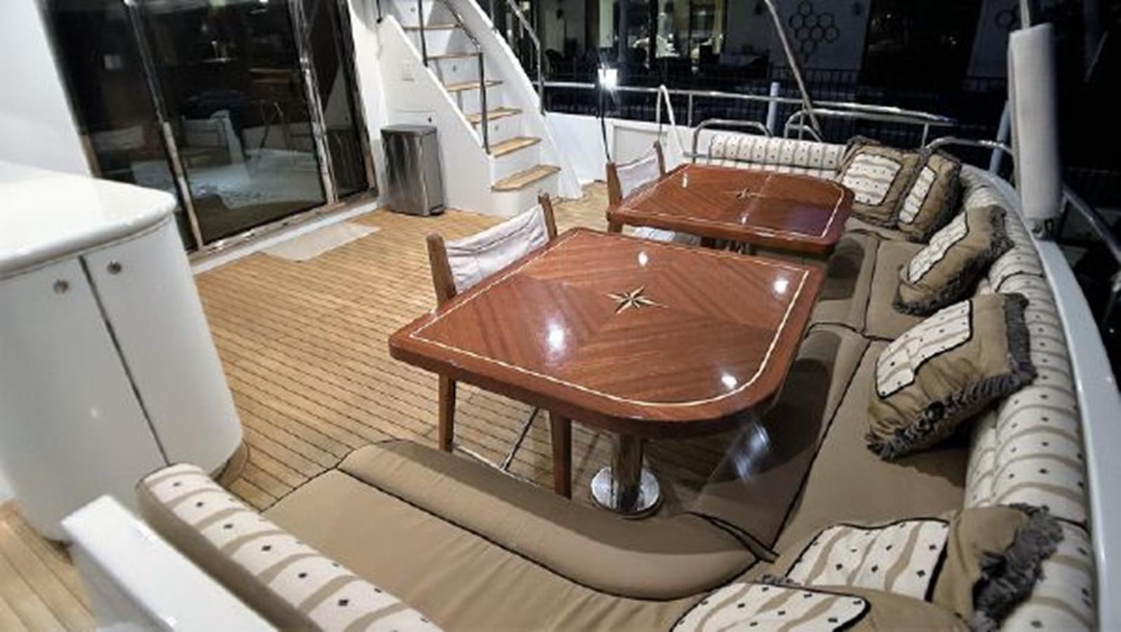 a table with a chair and a couch aboard 2006 CHEOY LEE MOTOR Yacht for Sale
