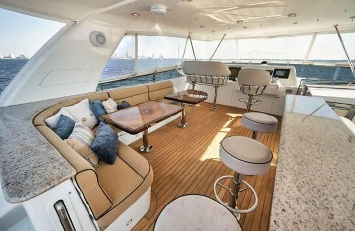 a room with a couch and a table and chairs aboard 2006 CHEOY LEE MOTOR Yacht for Sale