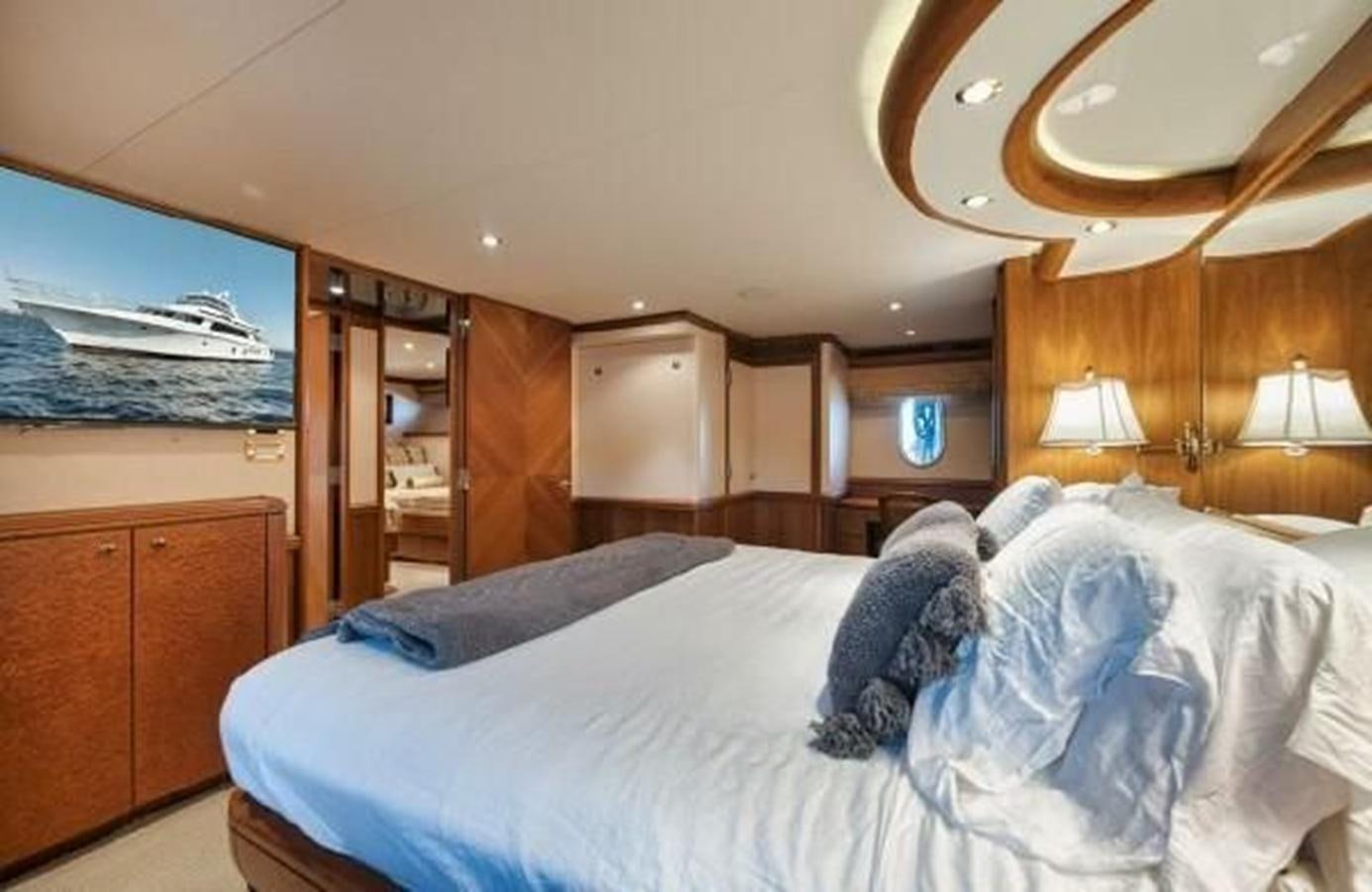 a bedroom with a bed and a closet aboard 2006 CHEOY LEE MOTOR Yacht for Sale