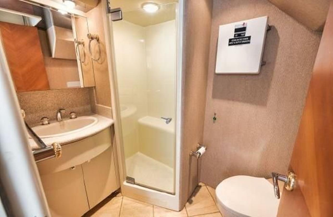 a bathroom with a sink and a toilet aboard 2006 CHEOY LEE MOTOR Yacht for Sale