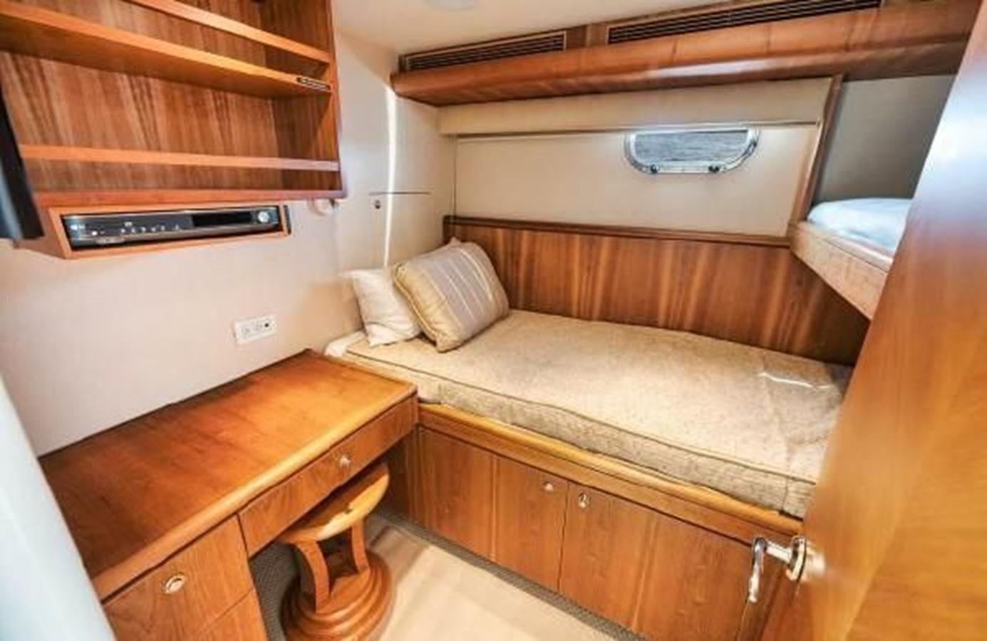 a room with a bed and a desk aboard 2006 CHEOY LEE MOTOR Yacht for Sale