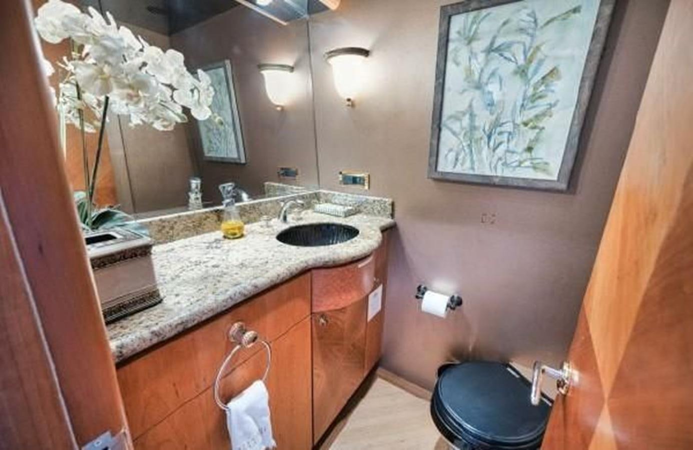 a bathroom with a sink and a mirror aboard 2006 CHEOY LEE MOTOR Yacht for Sale