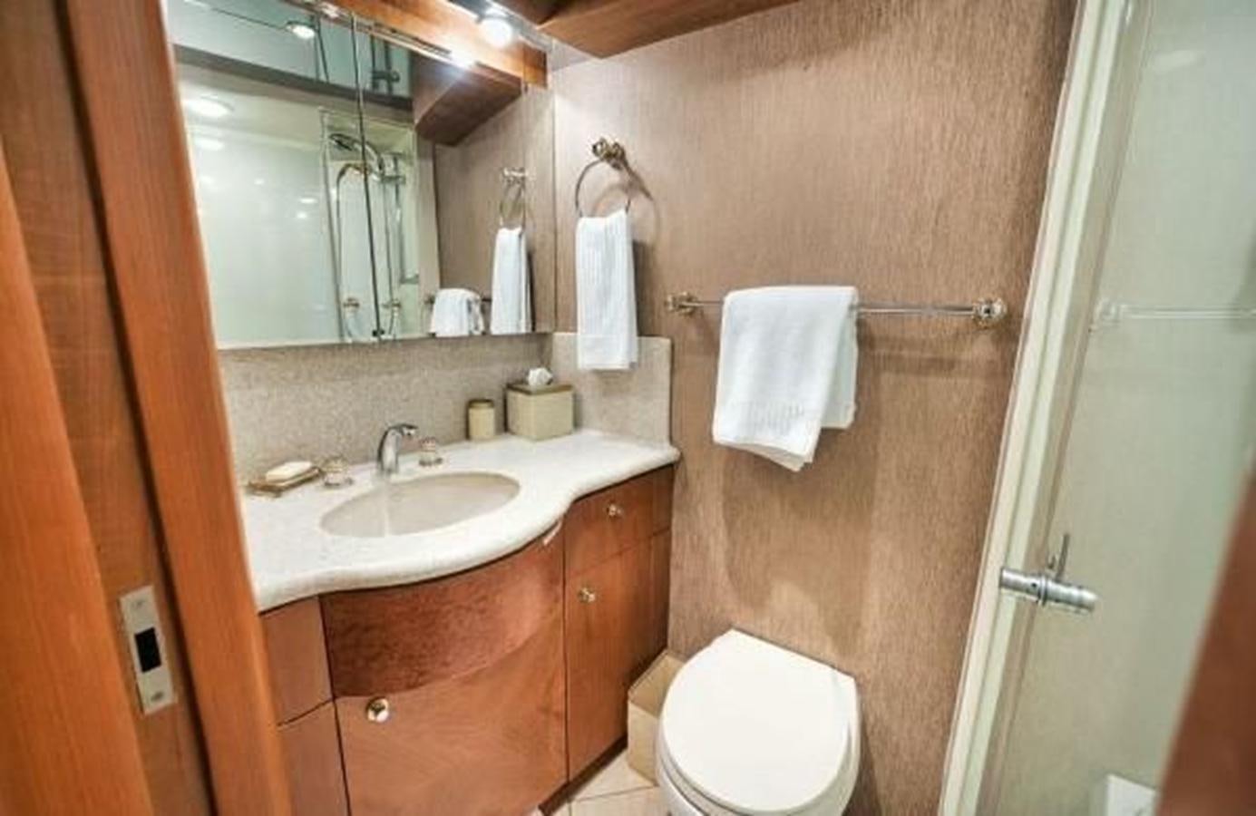 a bathroom with a sink toilet and a mirror aboard 2006 CHEOY LEE MOTOR Yacht for Sale