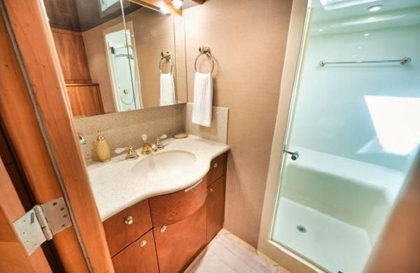 a bathroom with a sink and a mirror aboard 2006 CHEOY LEE MOTOR Yacht for Sale