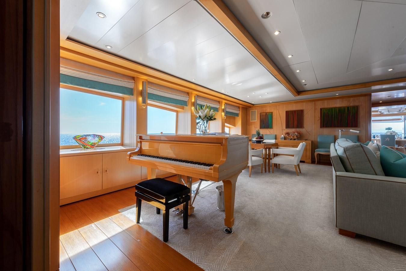 a room with a piano and a piano aboard AALTO Yacht for Sale