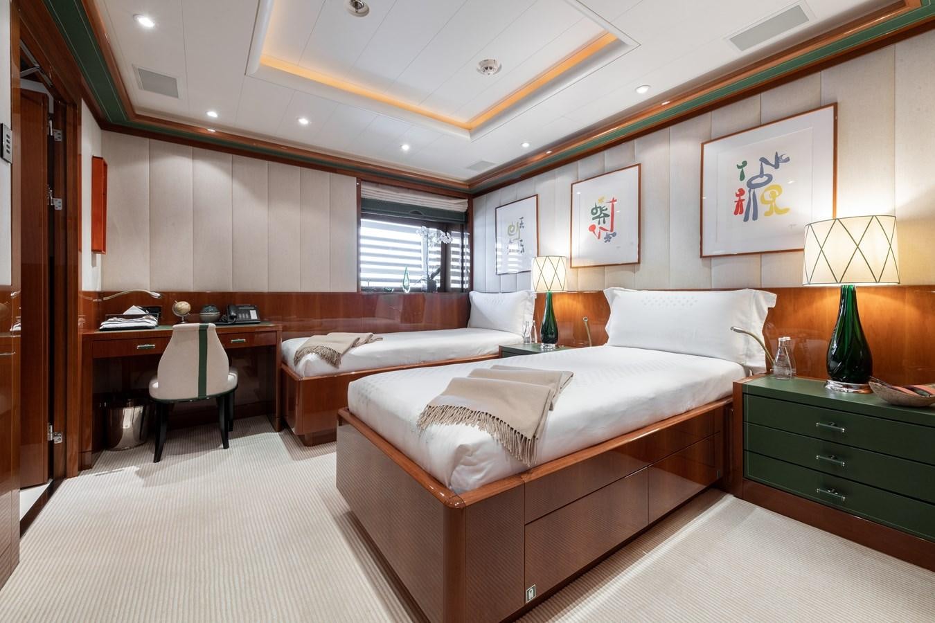 a hotel room with a bed and a desk aboard AALTO Yacht for Sale