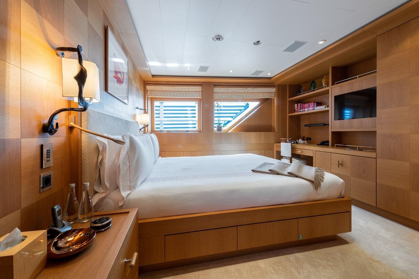 a bedroom with a bed and a desk aboard AALTO Yacht for Sale