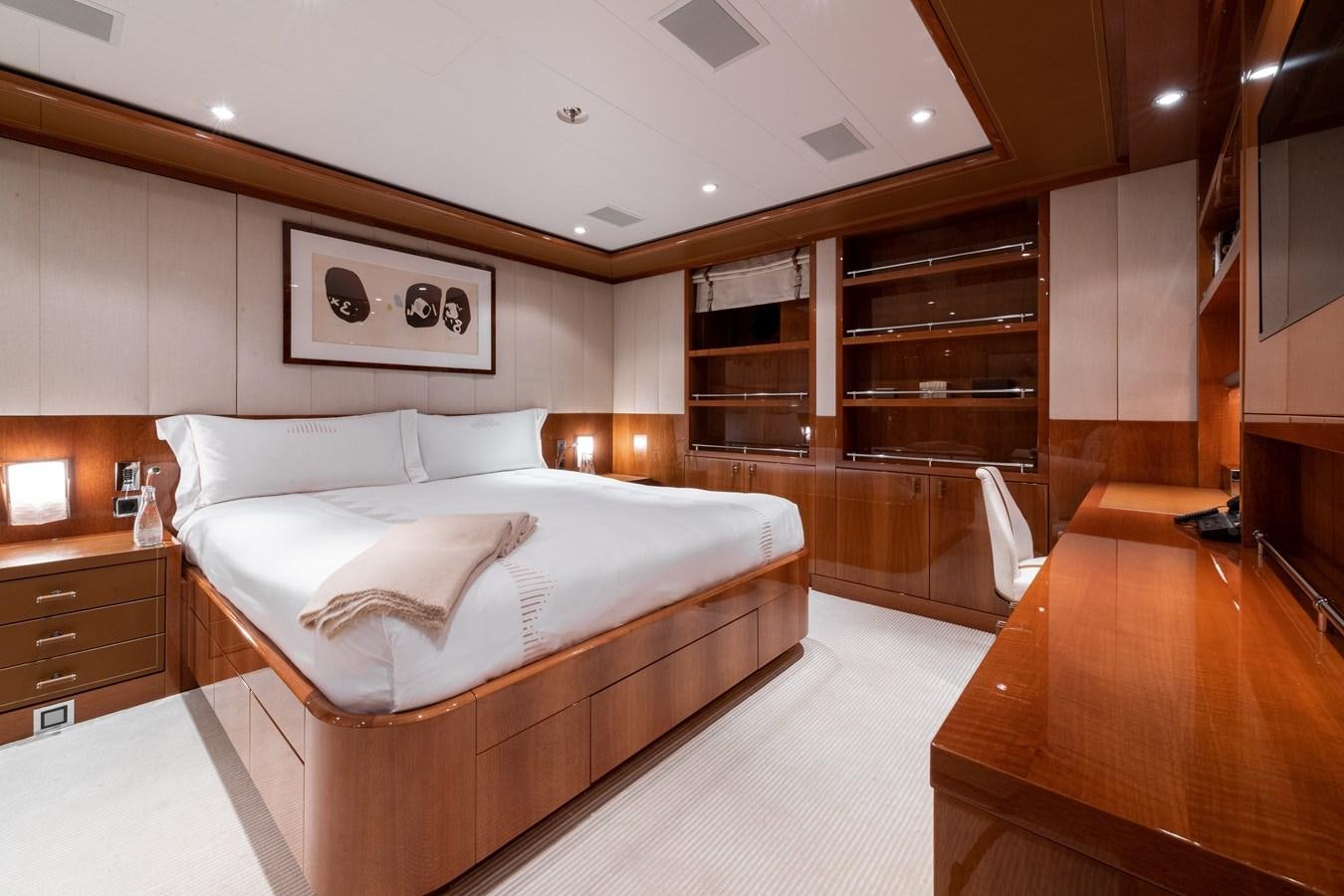 a bedroom with a bed and a desk aboard AALTO Yacht for Sale
