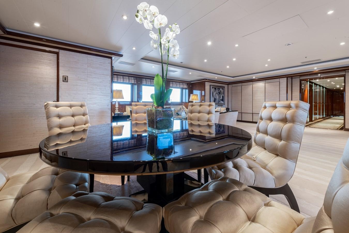 a living room with a table and couches aboard AALTO Yacht for Sale