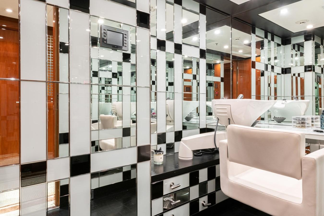 a room with a large display of electronics and a white chair aboard AALTO Yacht for Sale