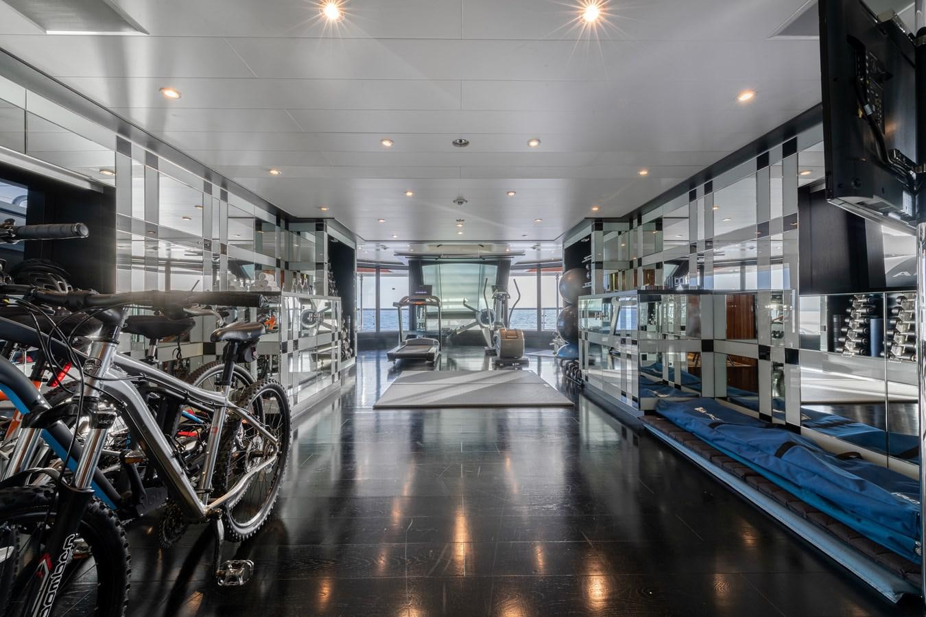 a room with a large mirror and bikes in it aboard AALTO Yacht for Sale