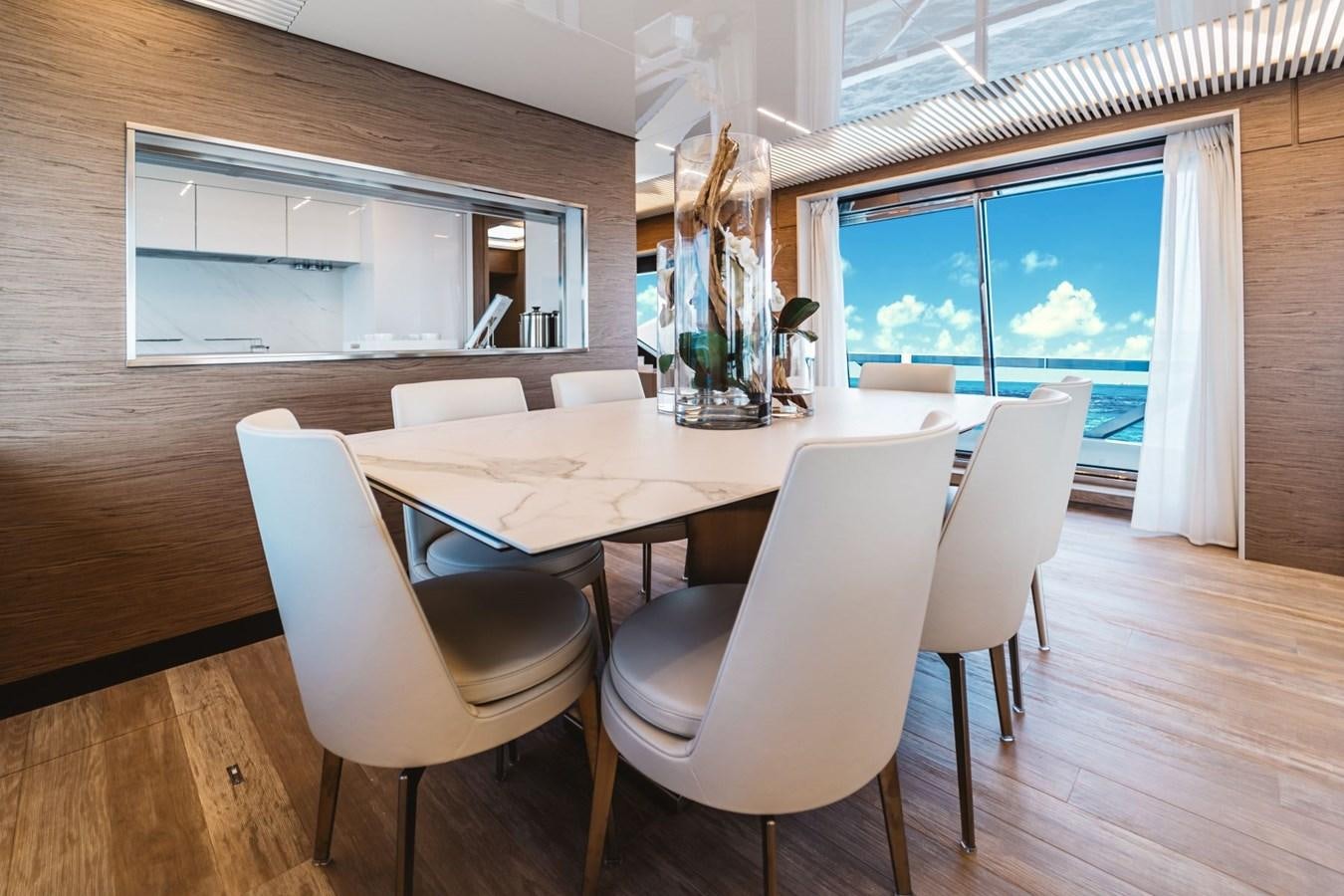 a room with a table and chairs aboard FERRETTI YACHTS 920 HT  Yacht for Sale